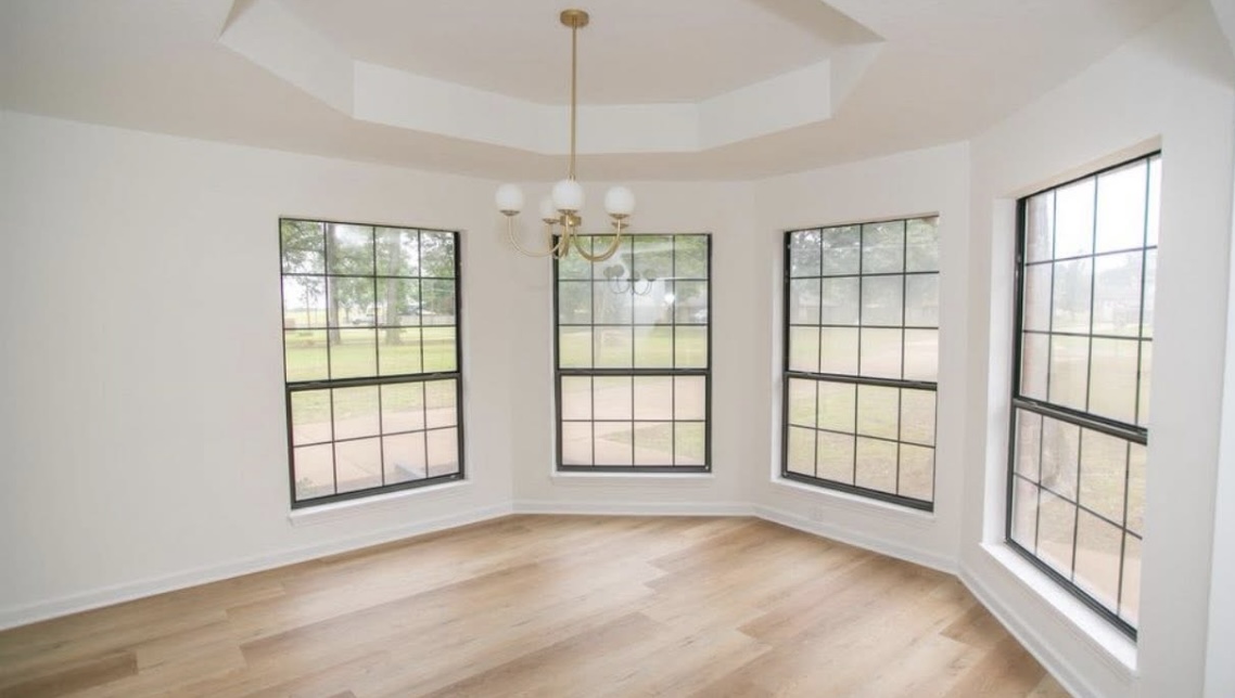 Dining area — windows and updated flooring · After renovation · Longview, Texas
