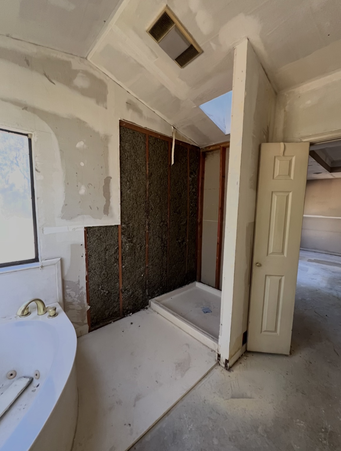 Bathroom — tub and unfinished shower area · During renovation · Longview, Texas