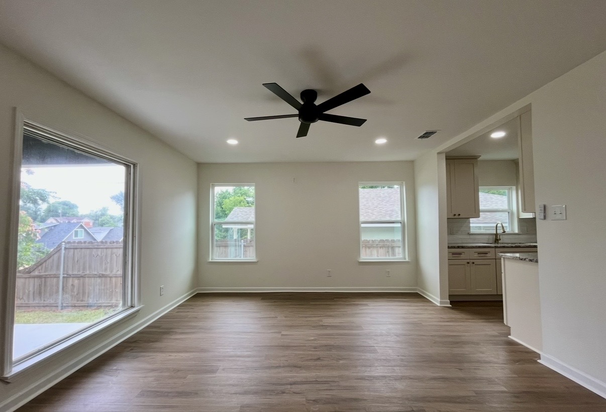 Living room — windows and kitchen opening · After renovation · Tyler, Texas