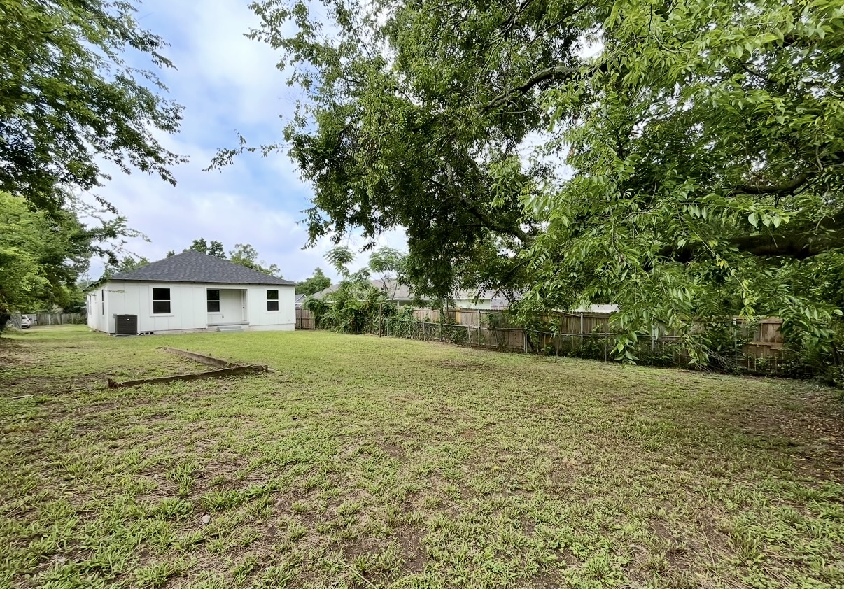 Backyard and rear exterior — wide view · After renovation · Tyler, Texas