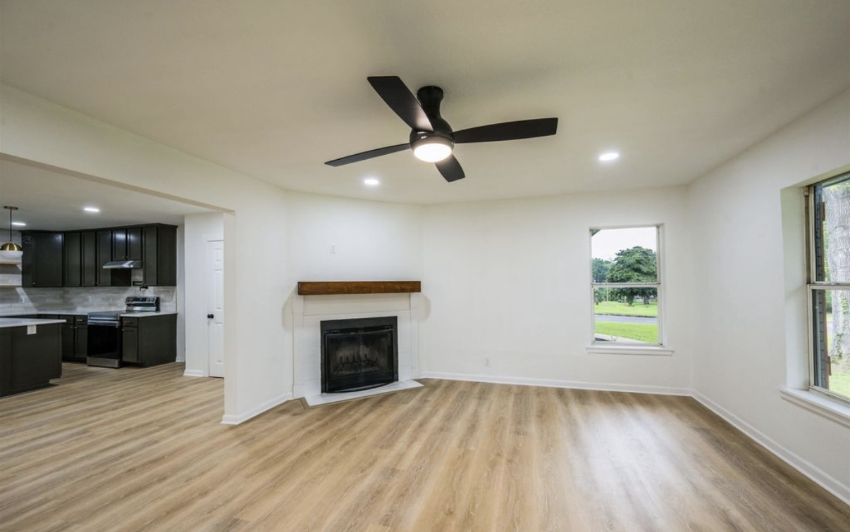 Completed living room — fireplace and kitchen view · Longview, Texas