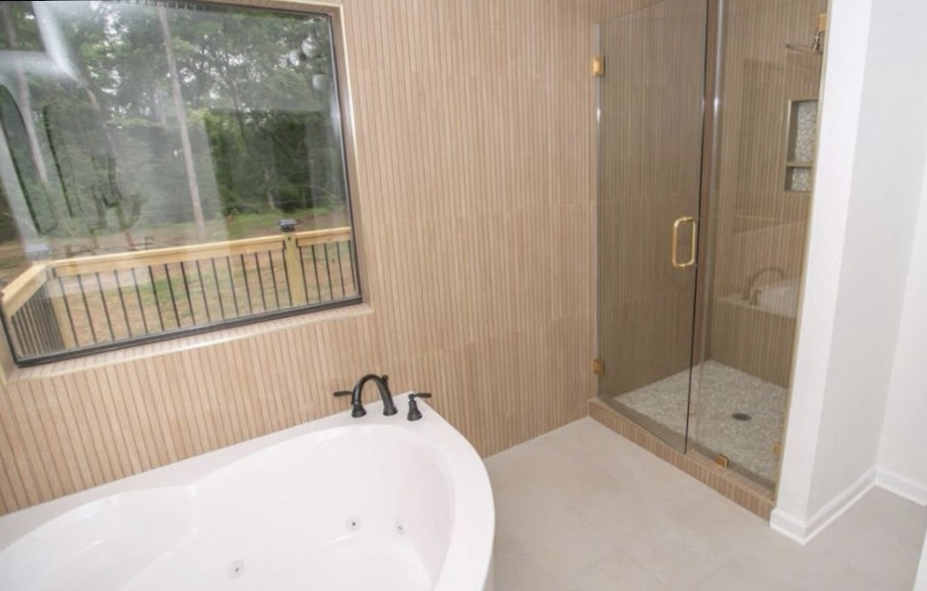 Bathroom — freestanding tub and glass shower · After renovation · Longview, Texas