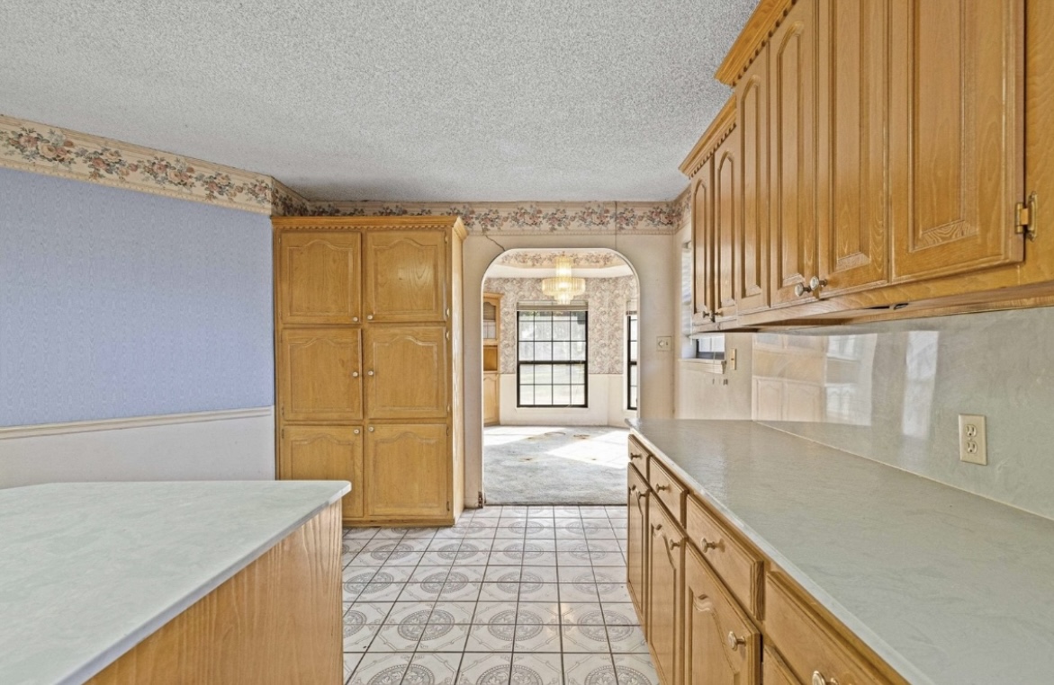 Kitchen — cabinetry and doorway · Before renovation · Longview, Texas