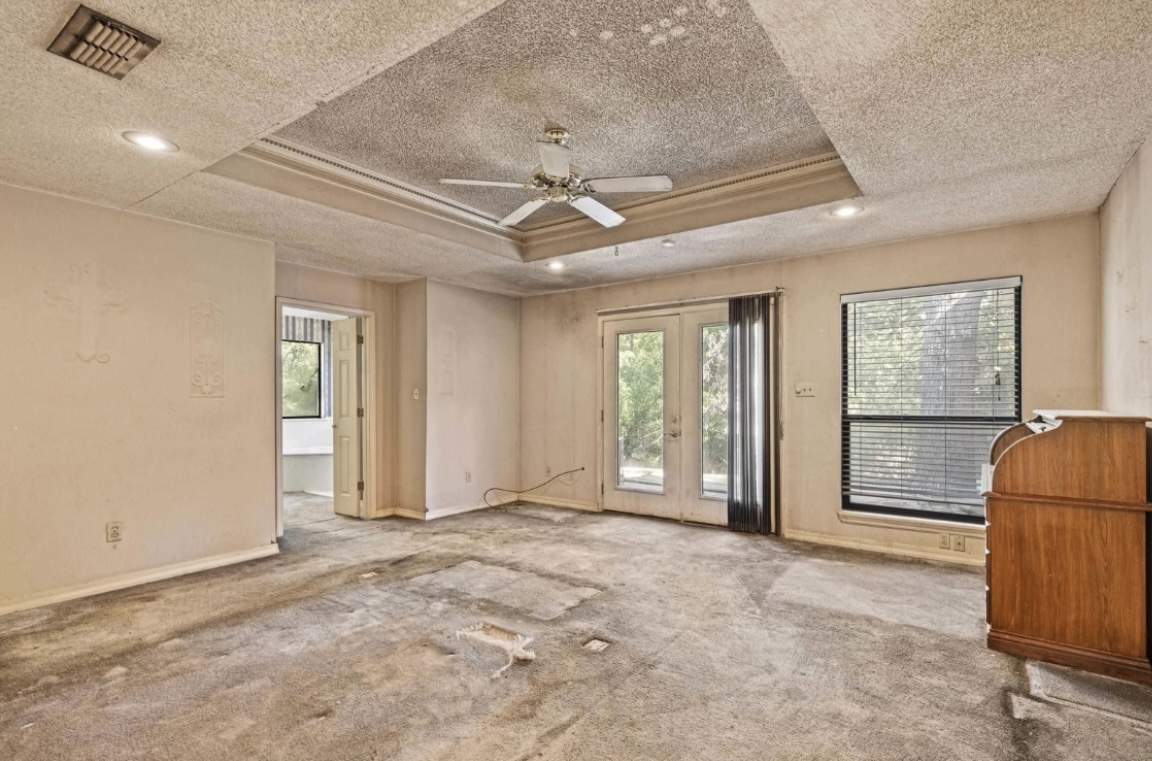 Bedroom — rear door and existing finishes · Before renovation · Longview, Texas