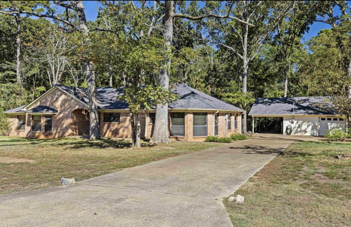 Front exterior from the driveway · Before renovation · Longview, Texas