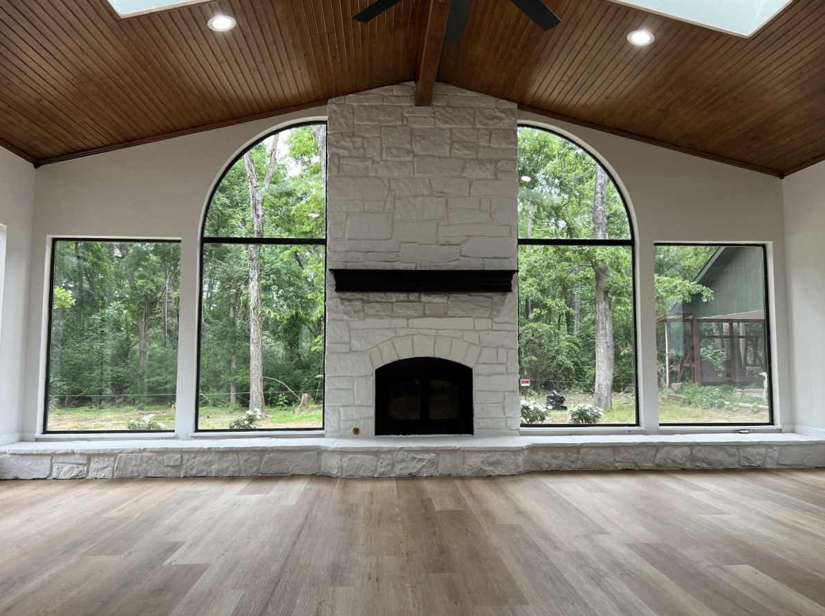 Full-height fireplace and arched windows · After renovation · Longview, Texas