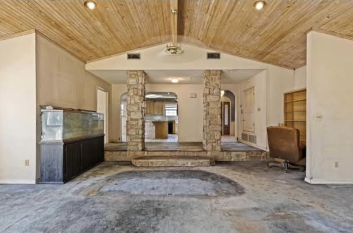 Sunken living room — stone archways · Before renovation · Longview, Texas