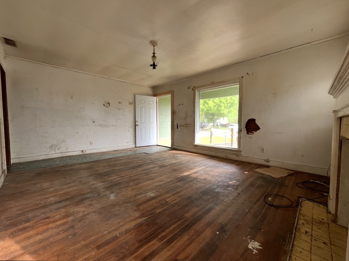 Living room — entrance and window · Before renovation · Tyler, Texas
