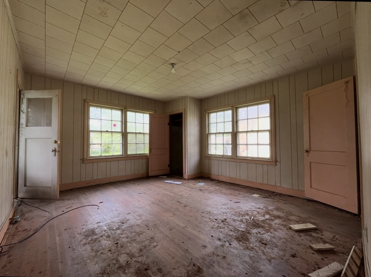 Room — paneled walls and windows · Before renovation · Tyler, Texas