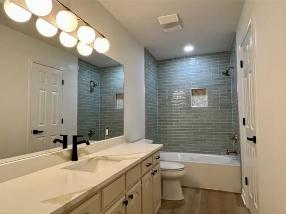 Bathroom — vanity and tiled tub surround · After renovation · Longview, Texas